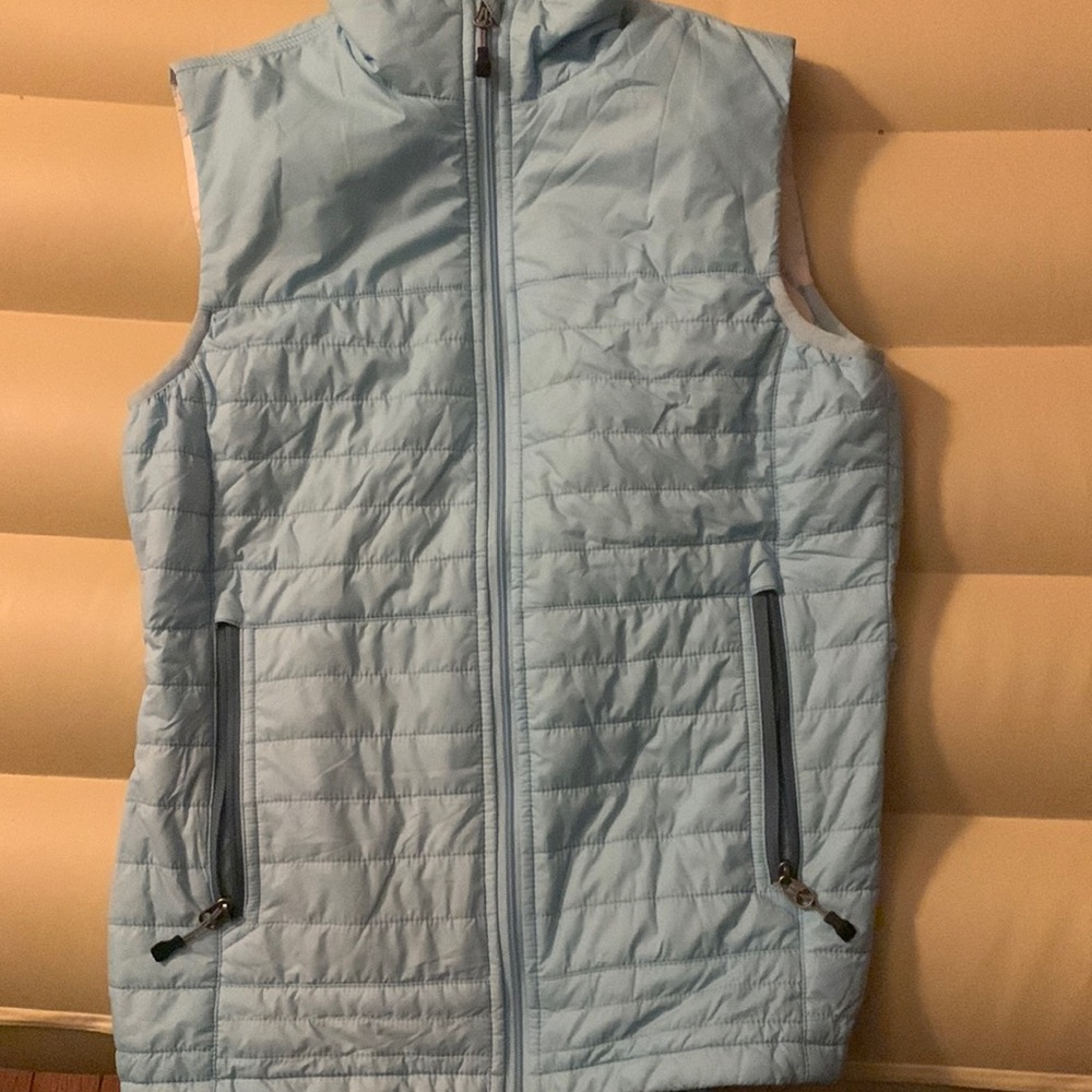 A baby blue vested jacket with a secret pocket